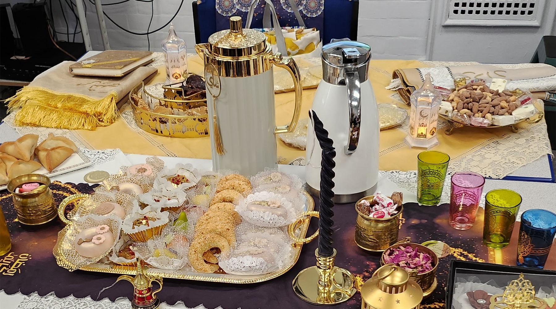 A table spread containing cultural food, snacks and ornaments