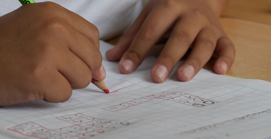 close up of child writing in their exercise book