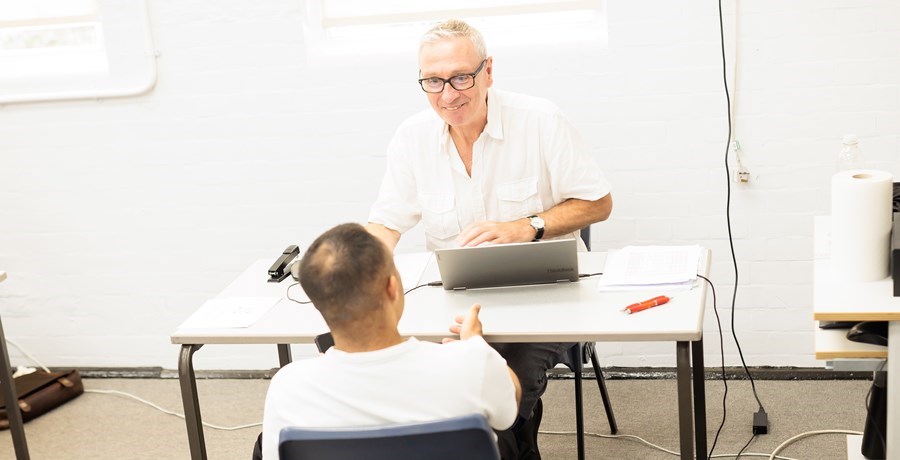 Man in white shirt interviewing another man