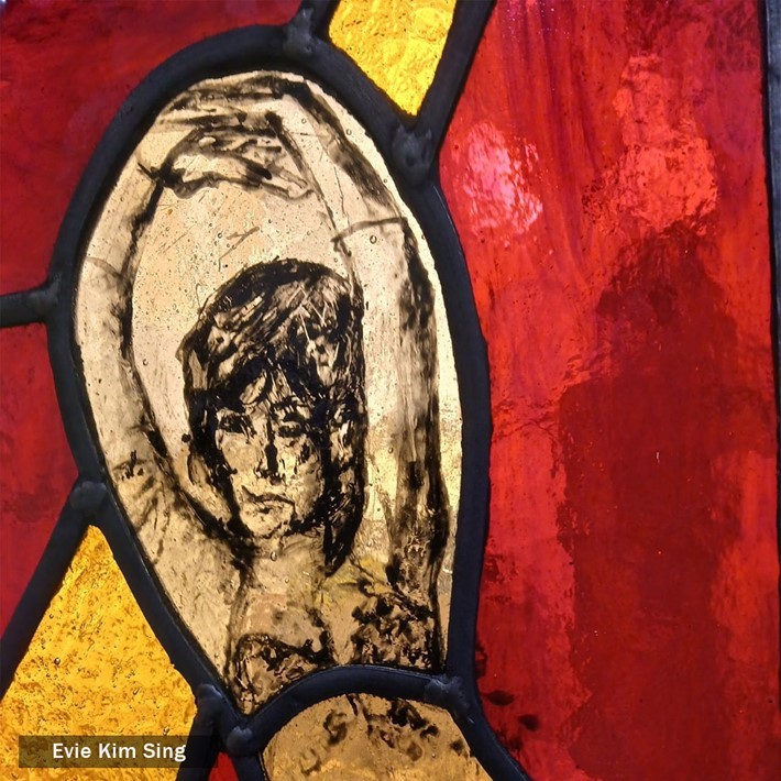 Stained glass person with red and yellow background