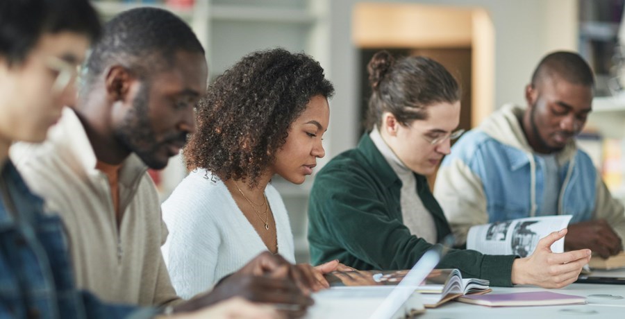 Men and women studying at a table