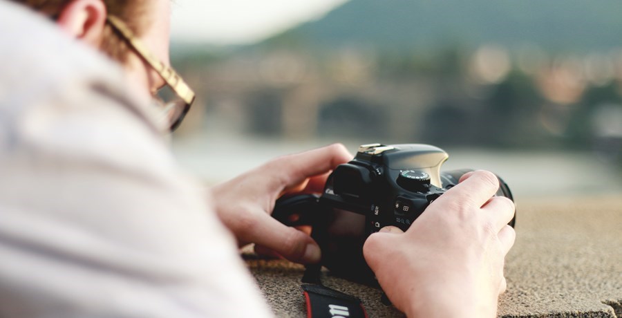 Man adjusting his camera to take a shot