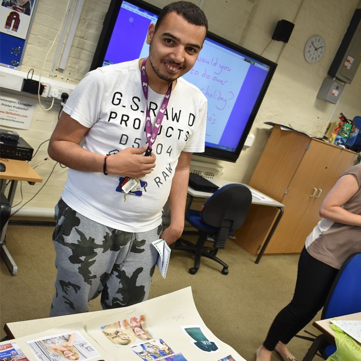 Man in a classroom with a lanyard around his neck