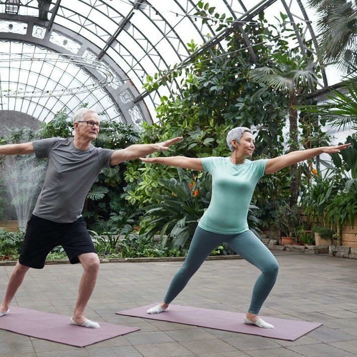 man and woman doing a yoga pose