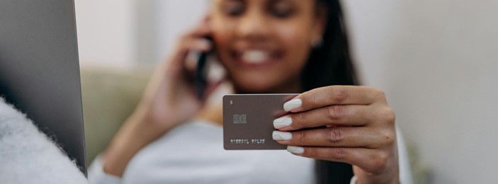 hands holding a credit card and a mobile phone