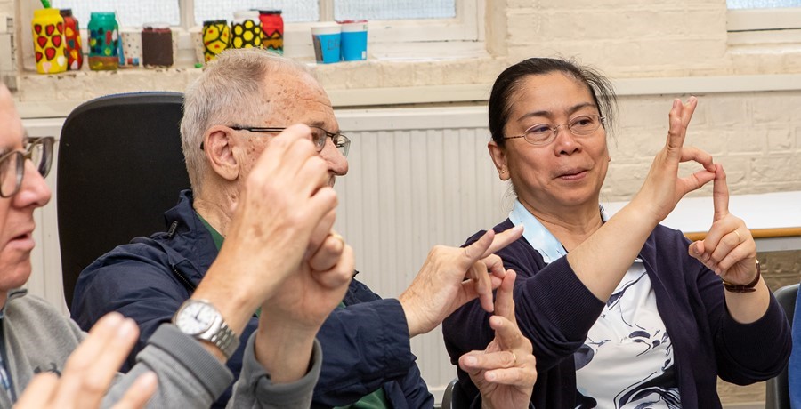 A group learning how to sign