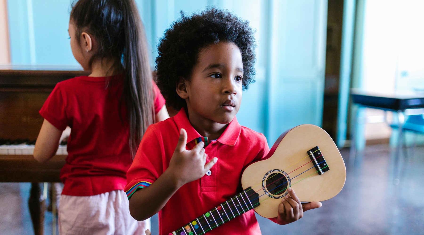 Little boy holding a ukulele