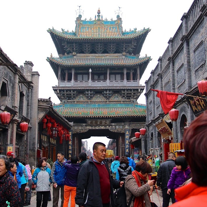 Chinese architecture in background and crowds of people foreground