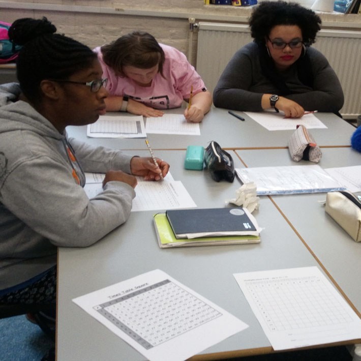 Group of ladies around a table writing