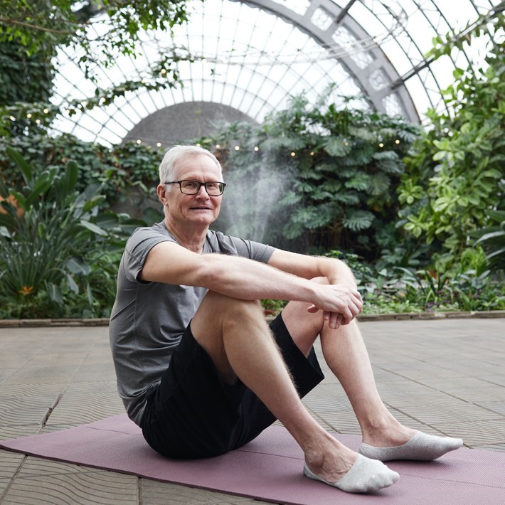 man sitting on a yoga matt