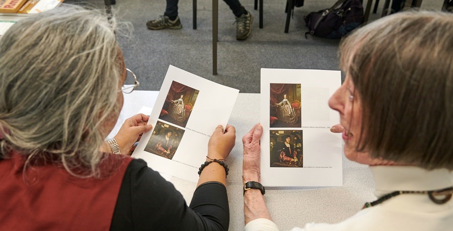 two ladies discussing art paintings